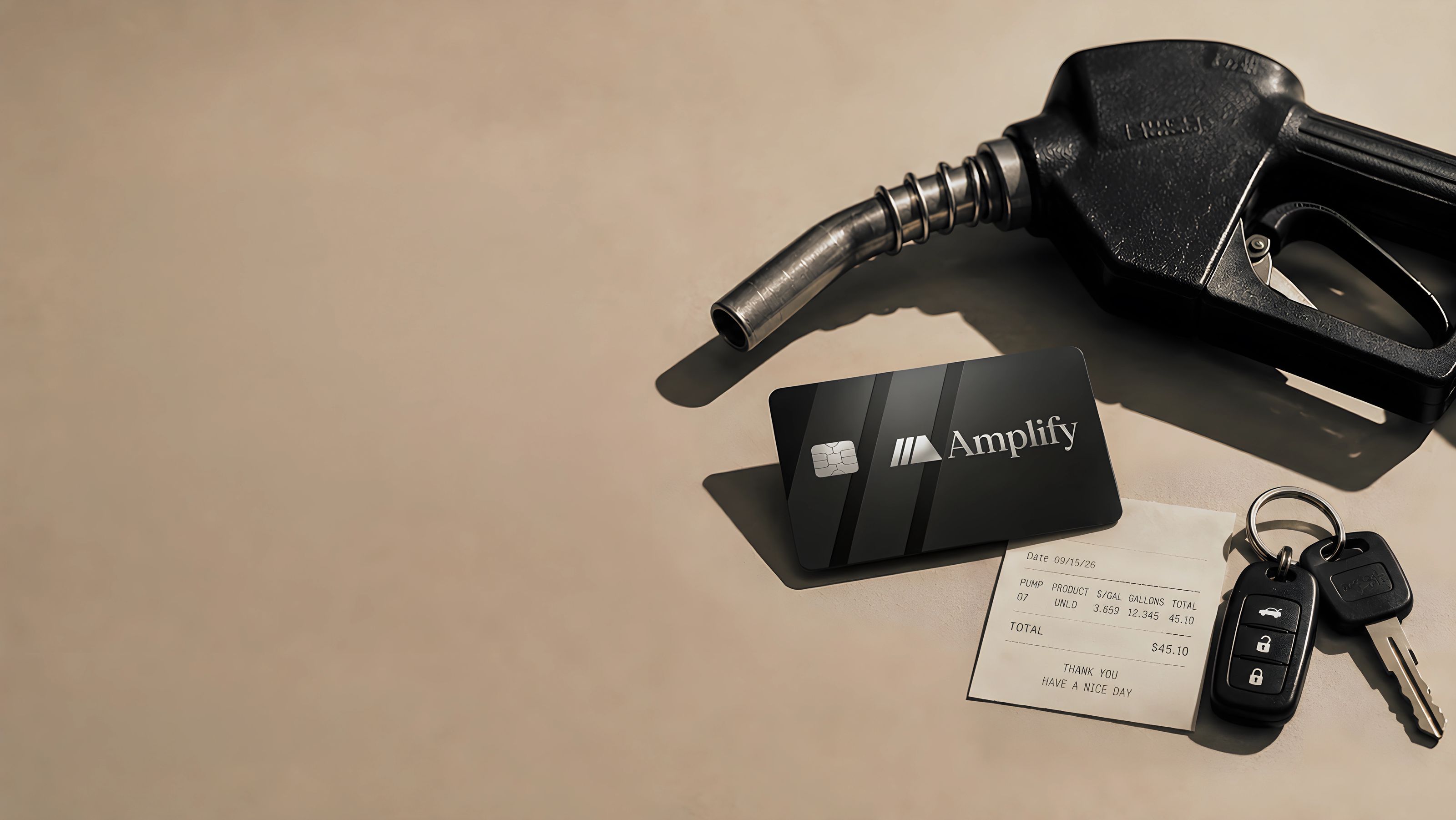 An Amplify card beside a fuel nozzle, a pump receipt for $45.10 and
                  a set of car keys